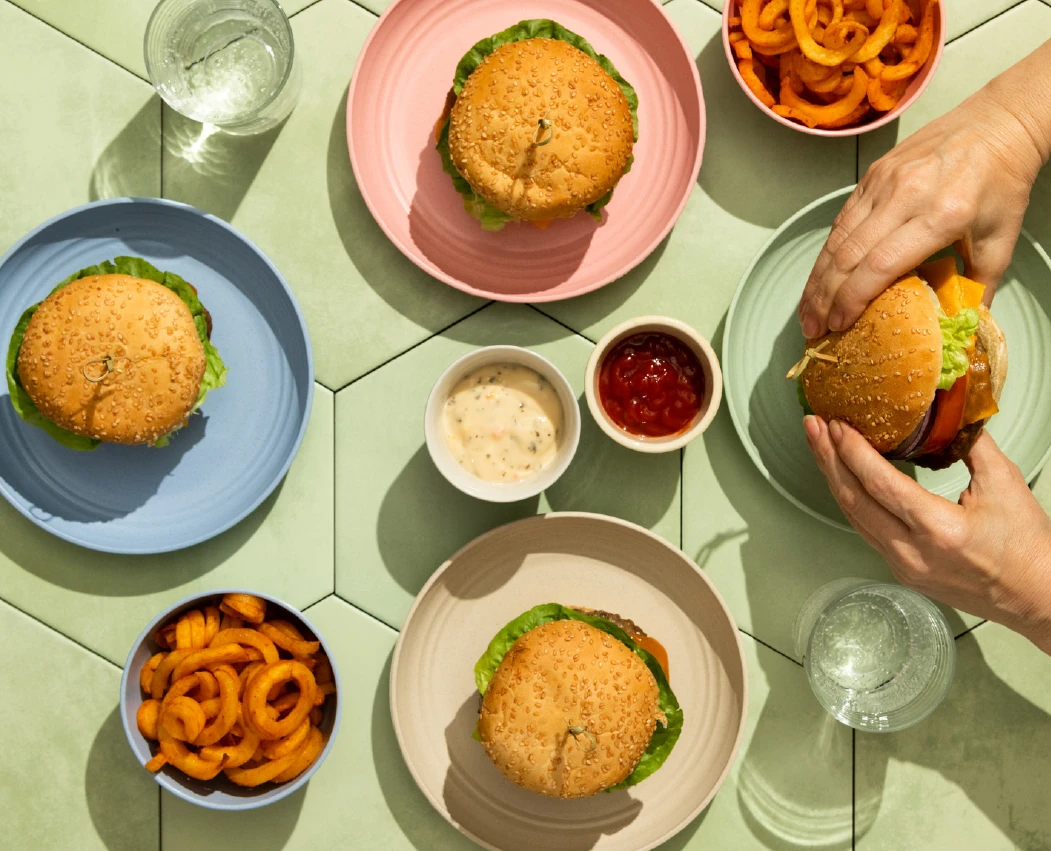 A colorful table with burger and fries from above