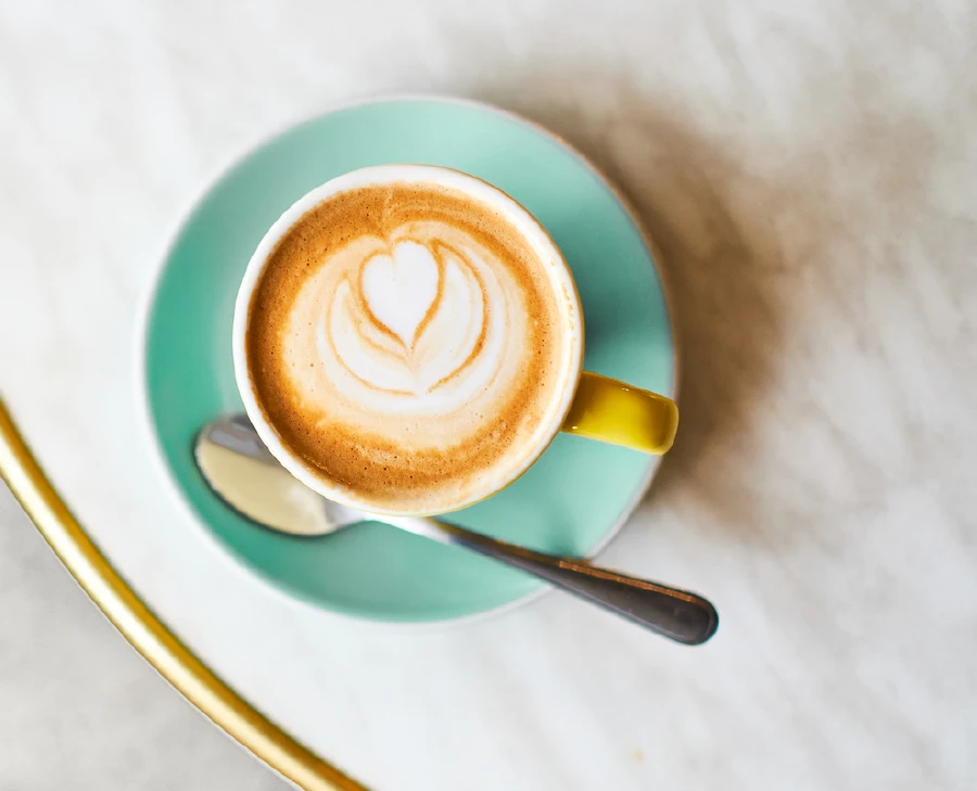 A cup of coffee on a marble table from above